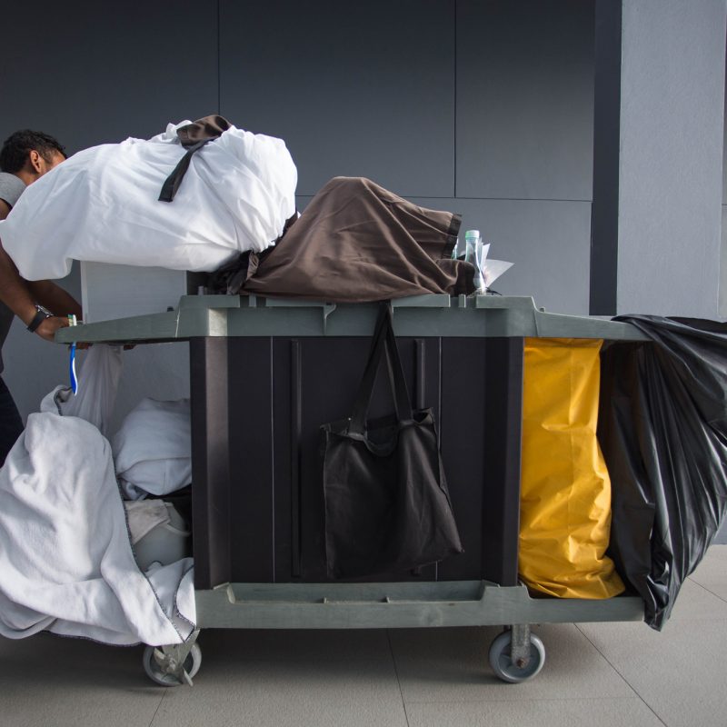 housekeeping staff throwing away trash at a hotel